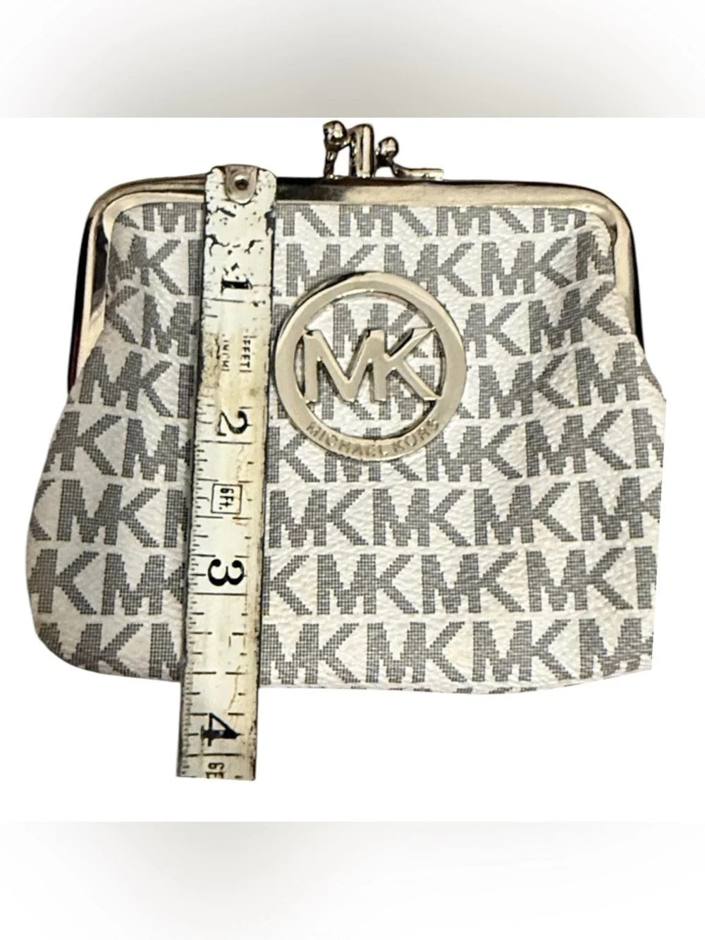 Michael Kors signature white and gray change purse with a clasp closure